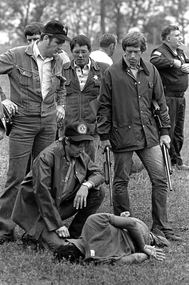 Fugitive Willie Joe Taylor on the ground Minutes after firing a single rifle shot that ended the flight of fugitive Willie Joe Taylor, the sharpshooter kneels at his side.
