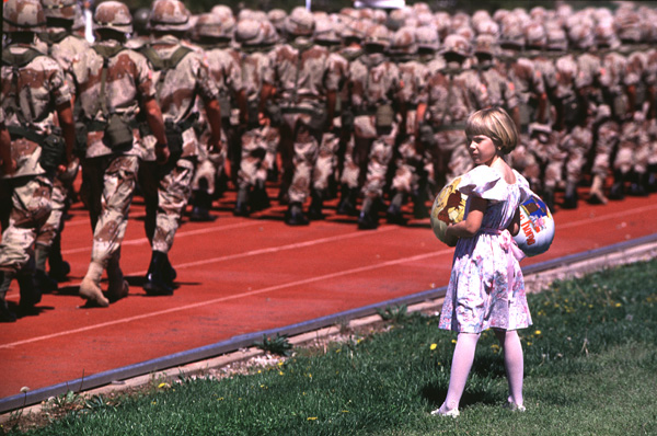 girl and soldiers A little girl looks for her uncle in a sea of desert camouflage.