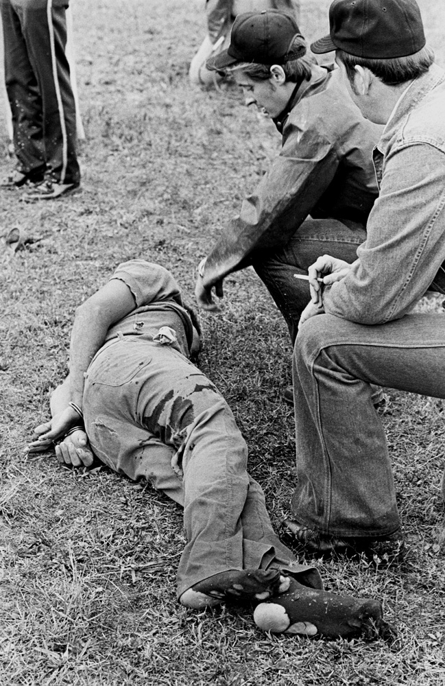 Fugitive Willie Joe Taylor after being shot The Missouri Water Patrol sharpshooter (center) kneels at a fugitive's side minutes after felling him with a single shot from across a field.